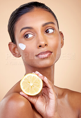 Buy stock photo Woman, lemon and cream for skincare, natural beauty product and cosmetics or vitamin c benefits while thinking. Face sunscreen, fruits and young person for skin dermatology on studio brown background