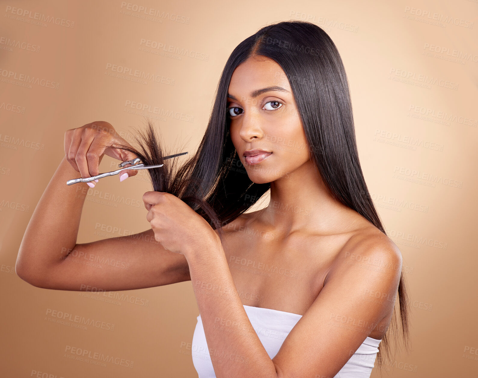 Buy stock photo Hair, portrait and Indian woman with scissors in studio for self haircut or trim on brown background. Haircare, face and female model with beauty tool for healthy growth, styling or cutting tips