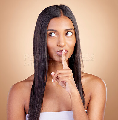 Buy stock photo Beauty, secret and woman with finger on mouth for skincare, wellness and cosmetics on brown background. Natural makeup silence, dermatology and smile on face, model with skin glow facial in studio.