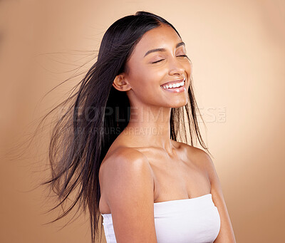 Buy stock photo Salon, hairstyle and indian woman with beauty or wind in brown studio background. Happy, girl and haircare with eyes closed or keratin treatment for shine or volume and natural cosmetics with glow.