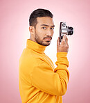 Portrait, man with a camera and creative photography or taking a picture for art, travel or record of a memory. Serious photographer, technology and shooting on retro or vintage film in studio