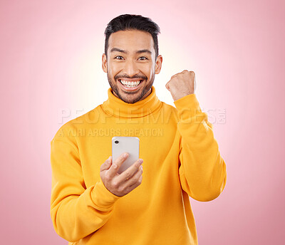 Buy stock photo Winner portrait, man and phone for success, yes and celebration of news, social media or gaming results. Excited, mobile games and person with notification or website bonus on studio, pink background