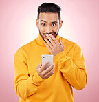 Phone, shock and portrait of a man in studio with a secret, gossip or fake news on social media. Male asian model with hand on mouth and smartphone for wow, surprise or chat on a pink background