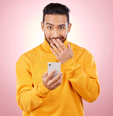 Buy stock photo Phone, shock and portrait of a man in studio with a secret, gossip or fake news on social media. Male asian model with hand on mouth and smartphone for wow, surprise or chat on a pink background