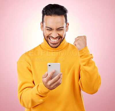 Buy stock photo Winner, man and phone for success, yes and celebration of online news, social media or gaming results. Excited, mobile games and person reading notification or website bonus on pink studio background