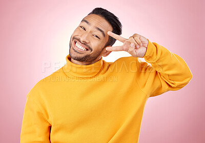 Buy stock photo Smile, peace sign and portrait of man in studio for support, kindness and happy. Emoji, happiness and thank you with face of person on pink background for mindfulness, vote and v hand gesture