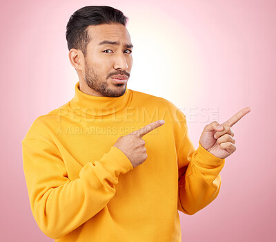 Buy stock photo Pointing finger, confused man and portrait in studio with announcement, promotion or decision. Face of serious male asian model with hands for marketing sale, doubt or presentation on pink background