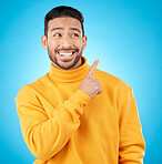 Asian man, smile and hand pointing to studio for news, deal and discount or how to guide on blue background. Happy, choice and male show timeline, checklist or direction, coming soon or sign up info