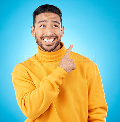 Buy stock photo Asian man, smile and hand pointing to studio for news, deal and discount or how to guide on blue background. Happy, choice and male show timeline, checklist or direction, coming soon or sign up info