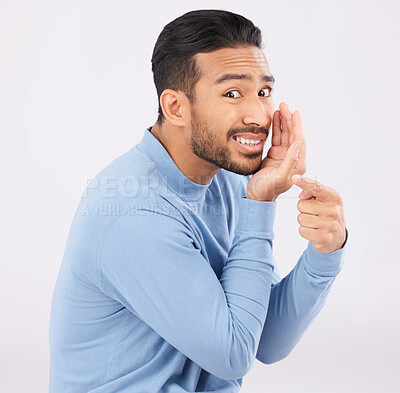 Buy stock photo Hand pointing, whisper and portrait of asian man in studio with secret, drama or rumor on grey background. Face, gossip and Japanese guy with bullying sign, body language or confidential sneaky news
