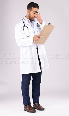 Buy stock photo Tired man, doctor and headache with clipboard in burnout, stress or overworked against a grey studio background. Medical or healthcare male person with head pain, mental health or bad clinic results