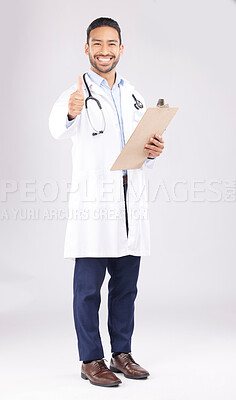 Buy stock photo Asian man, doctor and portrait with thumbs up for healthcare approval against a white studio background. Happy male person or medical expert smile with clipboard, like emoji or yes sign for success