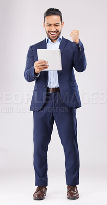 Buy stock photo Happy businessman, tablet and fist pump for winning, promotion or bonus against a grey studio background. Excited asian man in celebration on technology for good news, lottery prize or sale discount