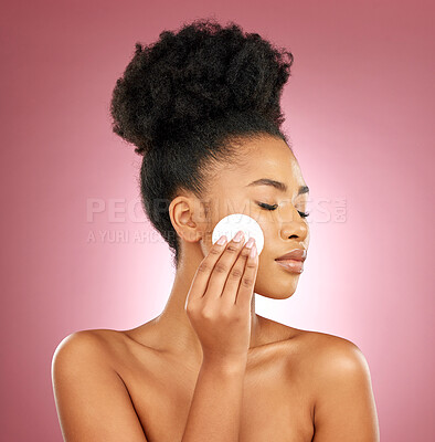 Buy stock photo Black woman, cotton pad and dermatology with makeup, facial and salon treatment on a studio background. Female person, shine or model with cosmetic tools, glow and cleaning with patches and aesthetic