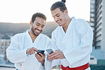 Happy, karate and men with phone in the city for martial arts, app information or social media. Smile, laughing and friends with a mobile for taekwondo training, fitness or a workout check online