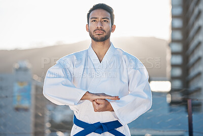 Buy stock photo Karate, exercise and focus with a sports man in the city for self defense training or a combat workout. Fitness, health and fighting with a serious young male athlete or warrior in an urban town