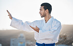 Karate, fitness and profile of a sports man in the city for self defense training or a combat workout. Exercise, mindset and fighting with a serious young male athlete or warrior in an urban town