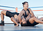 Men, wrestling and competition in a ring, mat or athlete winning in a tournament, match or training on floor of an arena. Fighting, match or championship gym with people grappling together for sport