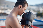 Sports, boxer praying or man fighting in a ring on rooftop in city for combat training or meditation to God. Eyes closed, athlete or fighter ready for boxing workout, fitness exercise or match battle