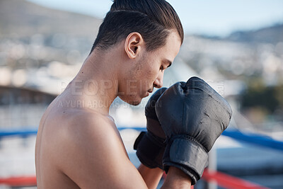 Buy stock photo Sports, boxer praying or man fighting in a ring on rooftop in city for combat training or meditation to God. Eyes closed, athlete or fighter ready for boxing workout, fitness exercise or match battle