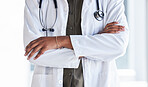 Hands, doctor and arms crossed in hospital for clinic services, consultation and medical support. Closeup of cardiology expert, therapist and healthcare worker ready for surgery consulting with trust