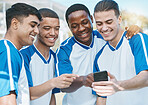 Happy man, friends and soccer team with phone for social media, communication or online browsing outdoors. Group of football players smile on mobile smartphone app together after workout practice