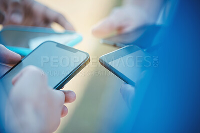 Buy stock photo Hands, phone and networking with people in a huddle or circle for communication or connectivity. Mobile, social media or information sharing and a person group standing together closeup with flare
