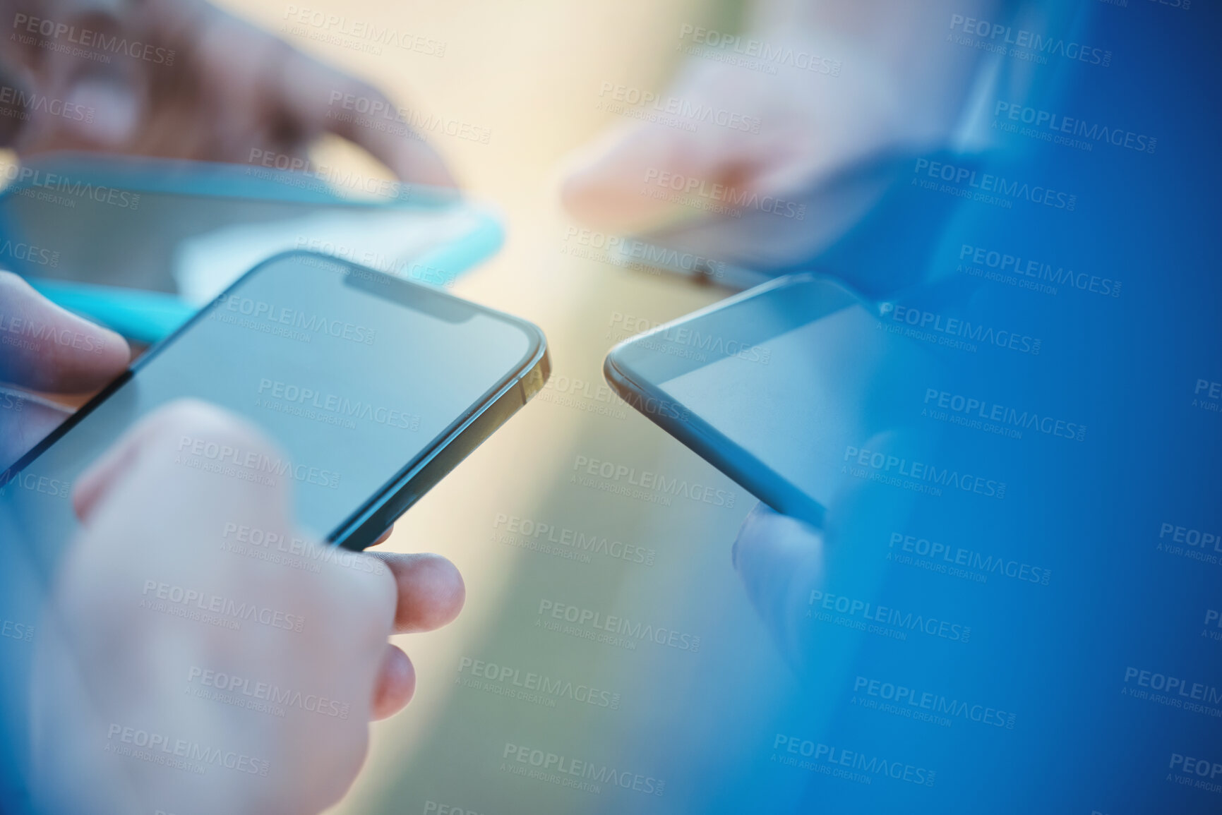 Buy stock photo Hands, phone and networking with people in a huddle or circle for communication or connectivity. Mobile, social media or information sharing and a person group standing together closeup with flare