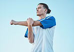 Soccer, fitness and stretching with a man on a blue sky background in preparation of a game or competition. Sports, health and warm up with a young male athlete getting ready for training or practice