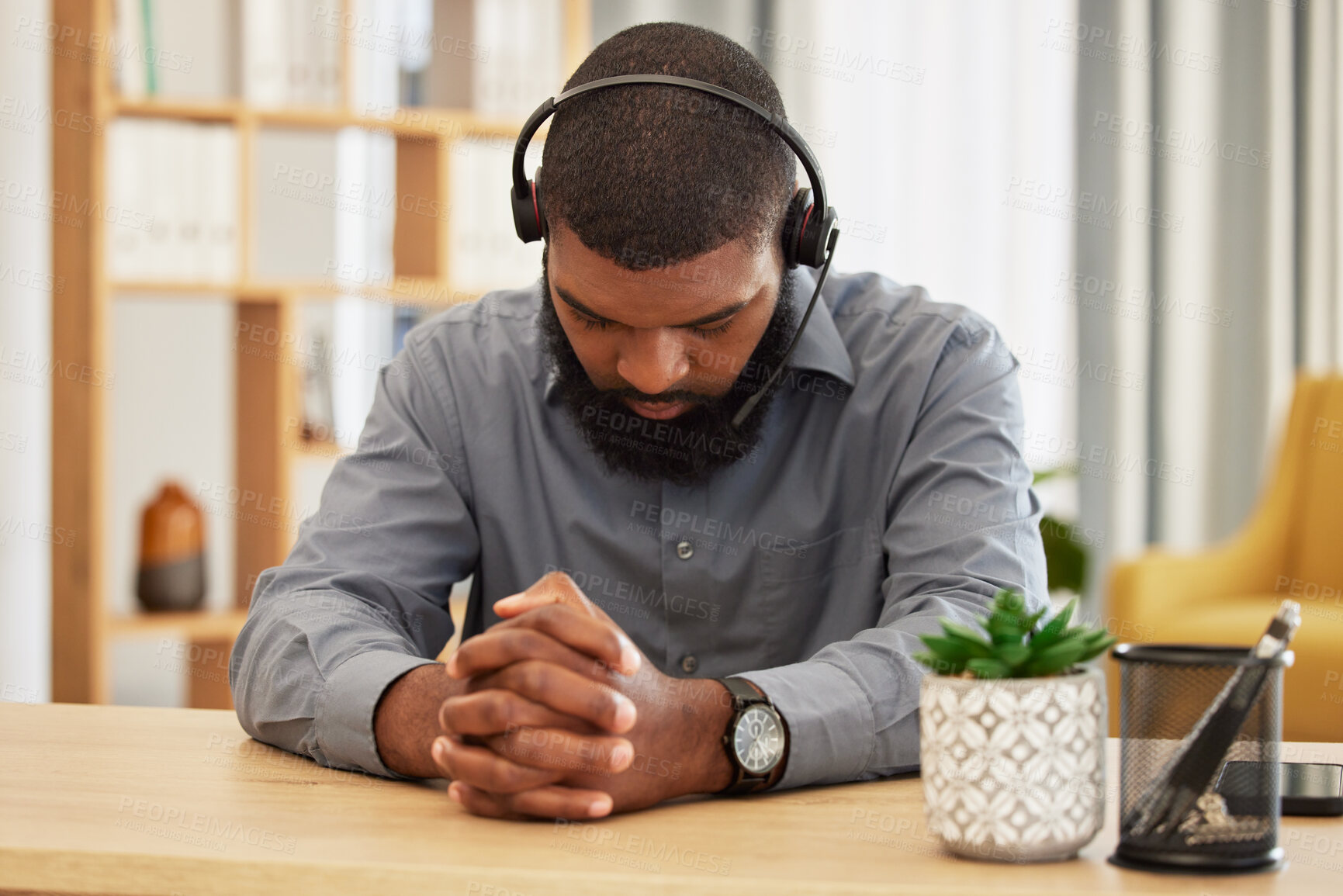 Buy stock photo Call center, stress and black man praying in office for workload, relief or mistake at desk. Telemarketing, fail and guy consultant pray for help with depression, anxiety or customer service pressure