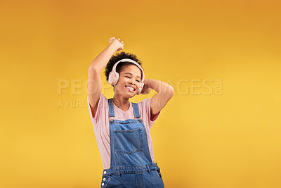 Buy stock photo Music, headphones and happy black woman, dancing and isolated in studio on a yellow background mockup space. African person, smile and listening to radio, podcast or sound for jazz, hip hop or audio