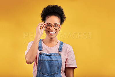Buy stock photo Portrait, glasses and smile with a black woman on a yellow background in studio for vision. Fashion, eyewear and a happy young afro female student at the optometrist for frame lenses or spectacles