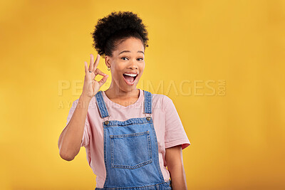 Buy stock photo Portrait, okay and hand gesture with a happy black woman in studio on a yellow background. Smile, wow and perfect with an excited young female person showing a sign of support, feedback or review