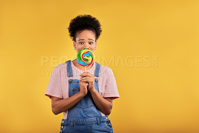 Buy stock photo Black woman, portrait with candy or lollipop in studio on yellow background and eating sweets, dessert or food with sugar. Gen z, girl and guilty pleasure in delicious treats, snack or product