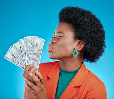 Buy stock photo Cash, kiss and a black woman lottery winner on a blue background in studio holding money for finance. Savings, investment or economy growth with a young female person posing for financial freedom