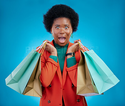 Buy stock photo Shopping bag, wow portrait and woman for fashion discount, giveaway or retail sales on blue background. Happy, excited or surprise face of customer, winner or african person in clothes deal in studio
