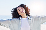 Woman at beach, freedom and travel with peace outdoor, mindfulness and calm with sunshine and fresh air. Young female person, carefree and zen with wellness, nature and summer with adventure 