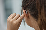 Hearing aid, closeup and ear of woman with disability from the back for medical support, listening or healthcare tech. Deaf female patient with audiology implant for sound waves, amplifier and volume