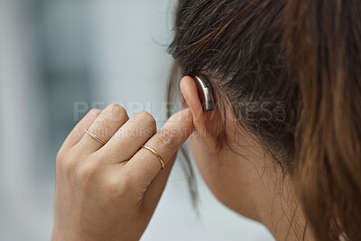 Buy stock photo Hearing aid, closeup and ear of woman with disability from the back for medical support, listening or healthcare tech. Deaf female patient with audiology implant for sound waves, amplifier and volume