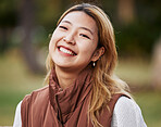 Happy, smile and portrait of Asian woman in park for holiday, freedom and relaxing outdoors. Happiness, nature and face of female person with joy, confidence and positive mindset for travel in summer