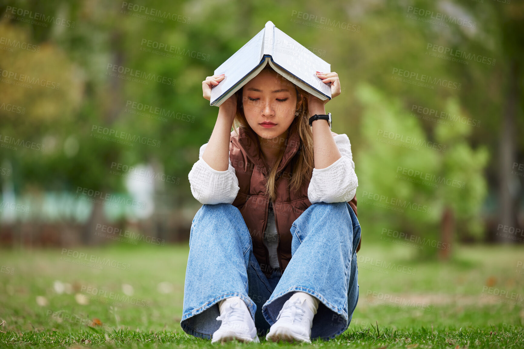 Buy stock photo Study, stress and book with woman in park for studying, thinking and depression. College, mental health and education with asian student on grass in nature for burnout, anxiety and fatigue problem