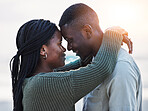 Couple, beach and touch forehead outdoor for love, care and commitment. Profile of a young black man and a happy woman together on a romantic vacation, holiday or sunset travel adventure in Jamaica
