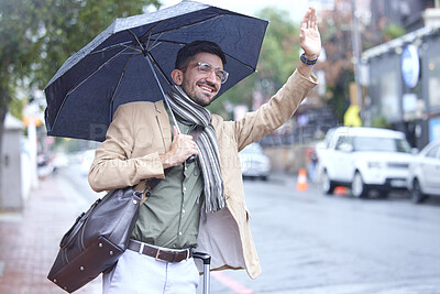 Buy stock photo Happy man, umbrella and taxi in city for travel, lift or pick up and waiting on sidewalk of road in rain. Male person waving hand for signal, trip or ride service by street in winter of an urban town