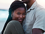 Black couple, hug and portrait outdoor at beach with love, care and commitment or security. Smile on face of young african woman and man together on vacation, holiday or travel adventure in Jamaica