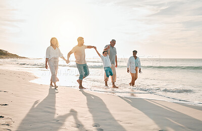 Buy stock photo Holding hands, swing and big family at the beach walking with freedom, travel and bonding at sunset. Love, lifting and and boy child with grandparents and parents at sea on walk for summer holiday