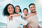 Family on beach, parents piggyback children in portrait with bonding on holiday, happy people and smile with travel. Mom, dad and young kids, tropical vacation in Mexico with love and care outdoor