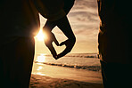 Silhouette, hands and heart, sunset on beach and solidarity with love and care, support and people together outdoor. Ocean, tropical holiday and nature, travel and calm with trust and adventure