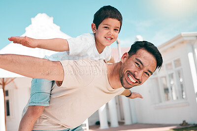 Buy stock photo Happy, airplane and portrait of a father with his child in the outdoor garden at their family home. Playful, smile and young dad carrying his boy kid on his back while bonding and playing together.