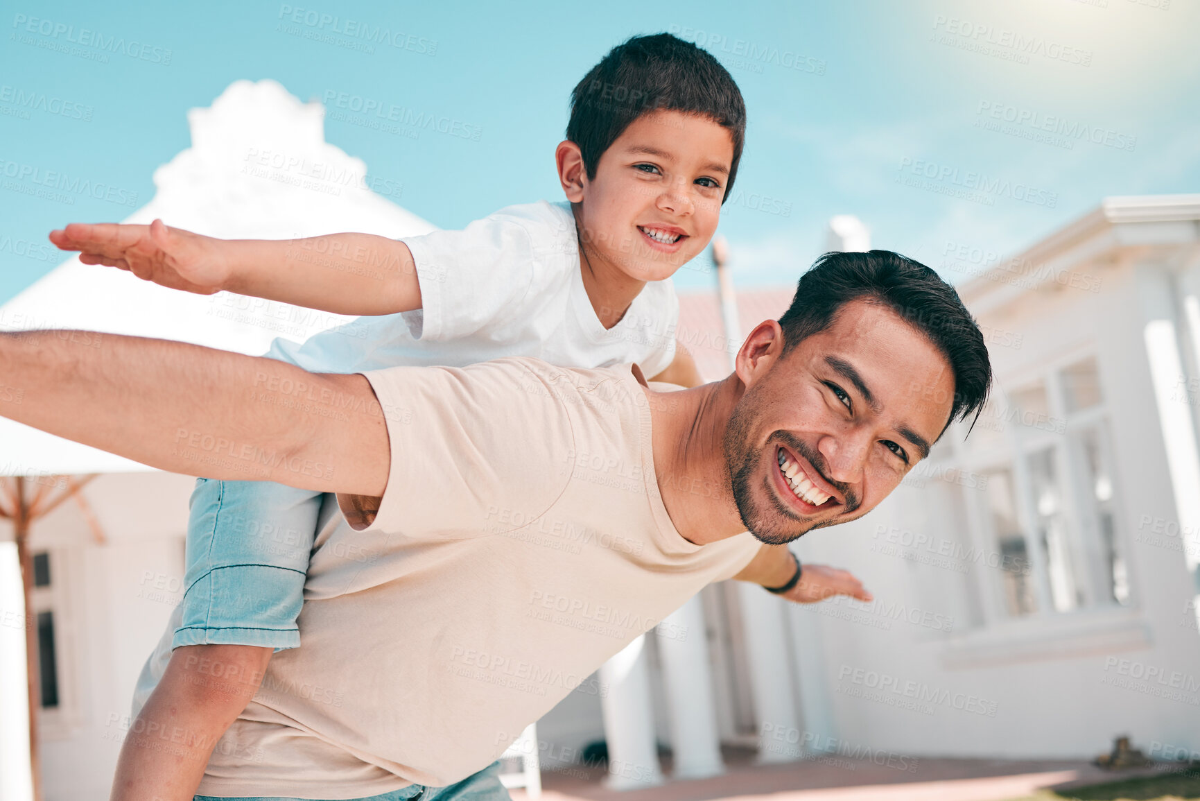 Buy stock photo Happy, airplane and portrait of a father with his child in the outdoor garden at their family home. Playful, smile and young dad carrying his boy kid on his back while bonding and playing together.