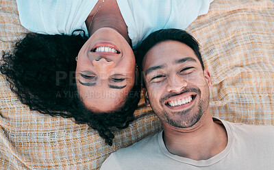 Buy stock photo Portrait, picnic and smile with a couple on a blanket from above, lying down on the ground while on a date. Face, love or happy with a man and woman bonding together for romance on valentines day